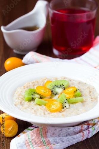 Oat porridge with fruit, orange, cumquat, kiwi, maple syrup