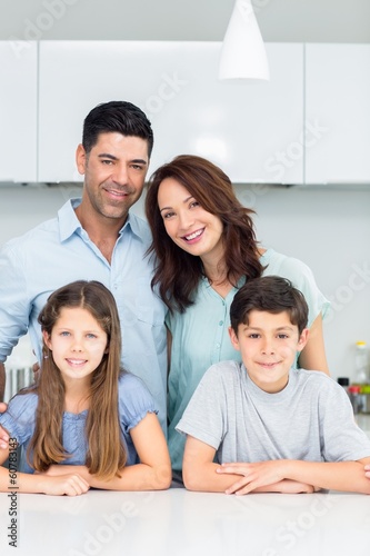 Portrait of a happy family of four in kitchen
