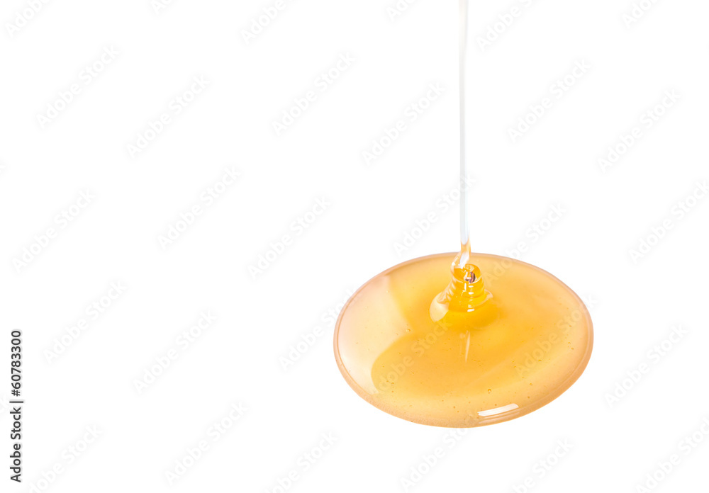 Pouring honey over white background Pouring honey over white background