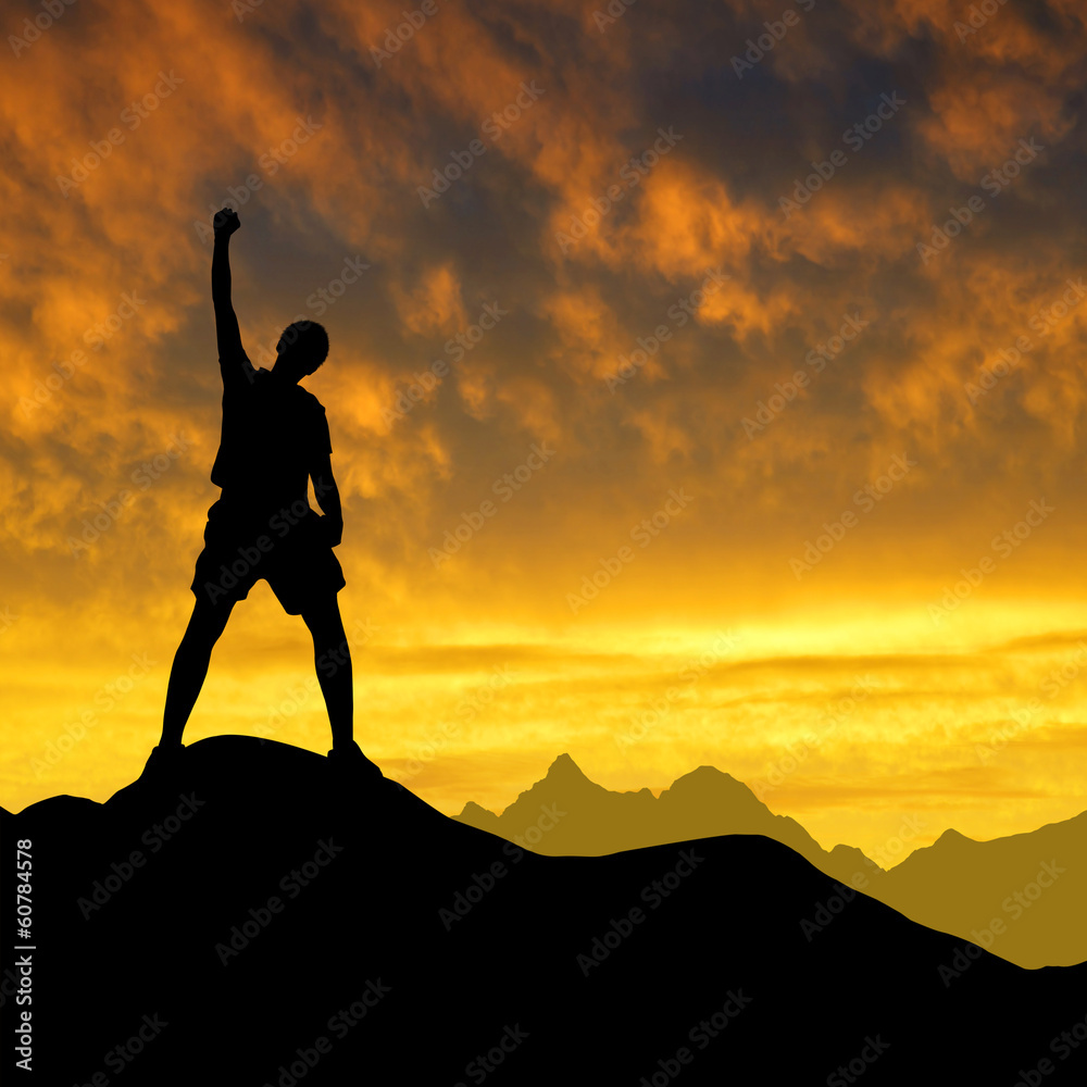 Silhouette of tourist on the top in the sunset.