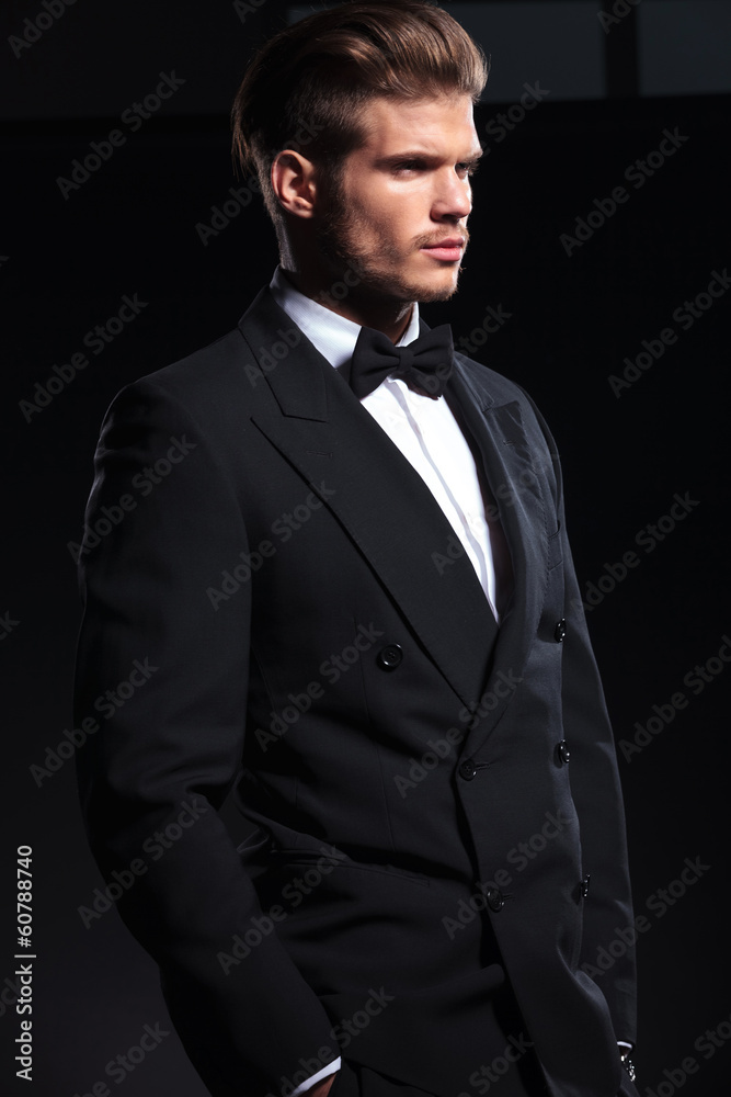 side view of an elegant man with hands in pockets side view of an elegant man with hands in pockets