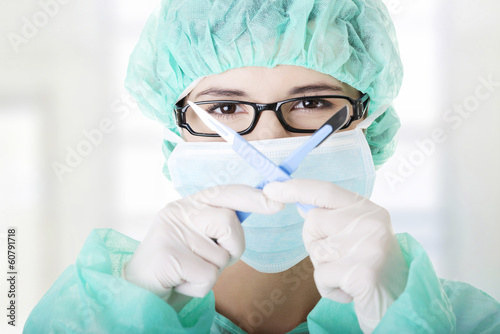 Woman doctor or nurse holding scalpel