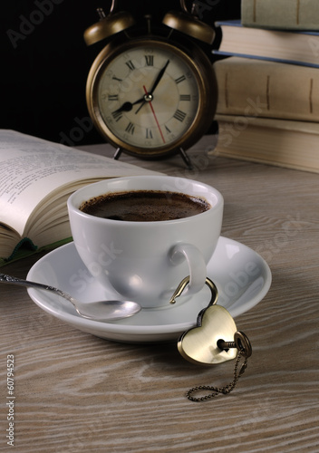 Heart shaped lock and key with a cup of coffee