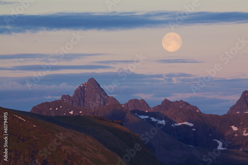 Moon above rocky peaks