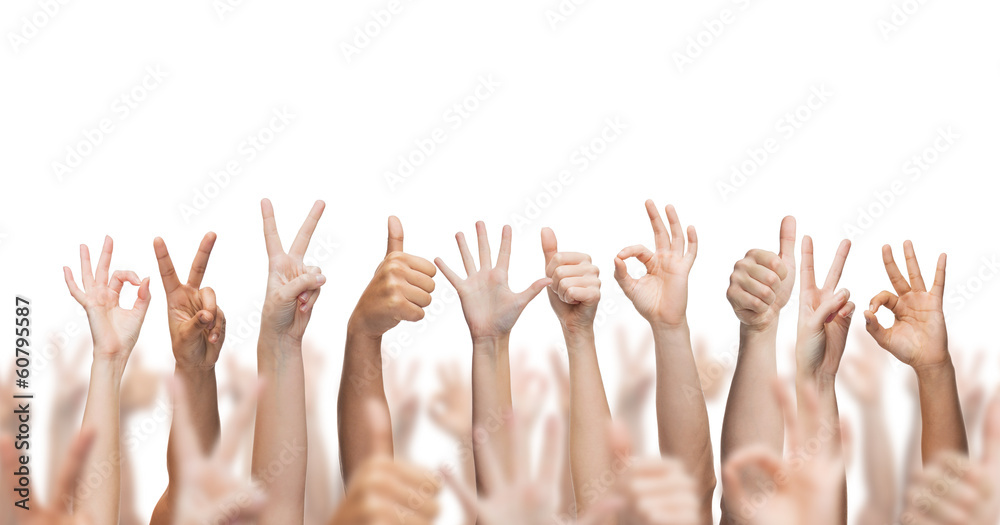 human hands showing thumbs up, ok and peace signs