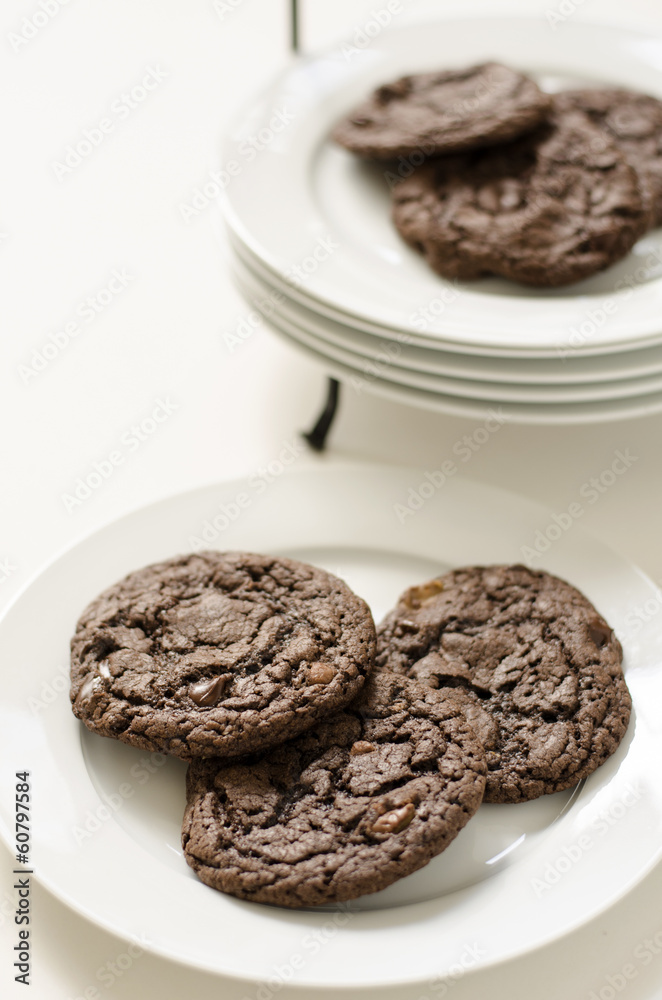 Chocolate chip and toffee cookies on a white serving plate Chocolate chip and toffee cookies on a white serving plate