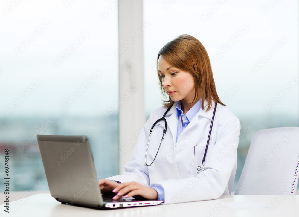 busy doctor with laptop computer busy doctor with laptop computer