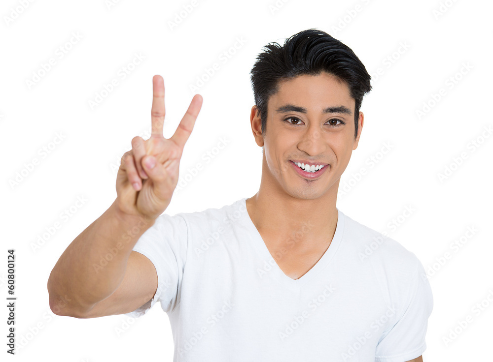 Happy, smiling young man holding up peace sign Happy, smiling young man holding up peace sign