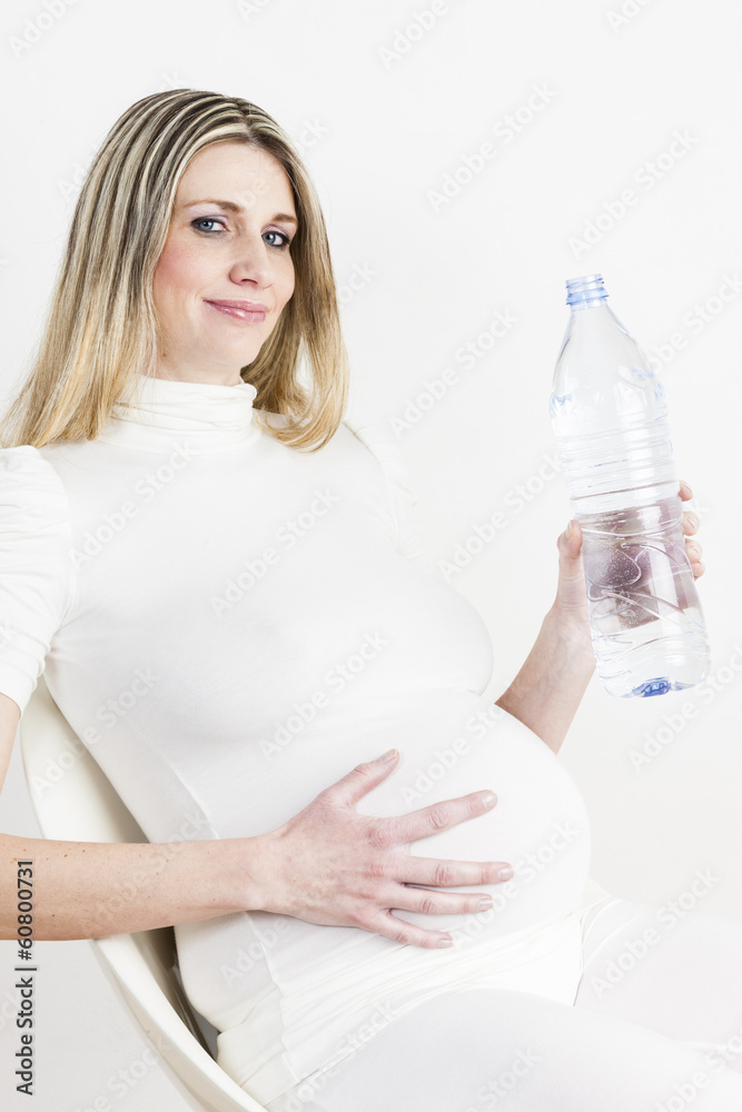 portrait of pregnant woman with a bottle of water portrait of pregnant woman with a bottle of water