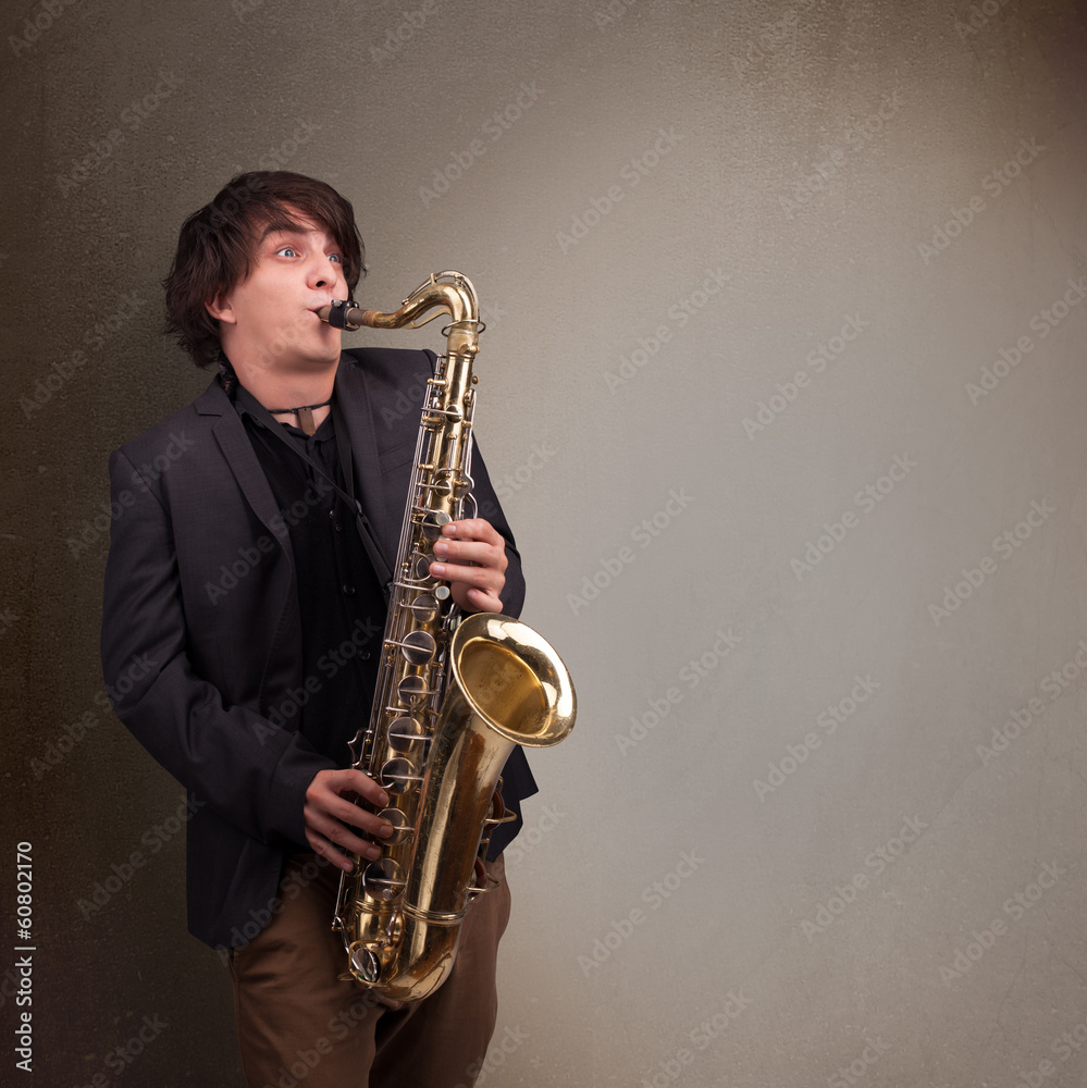 Fototapeta premium Young musician playing on saxophone