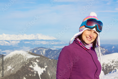 Smiling girl in winter mountains