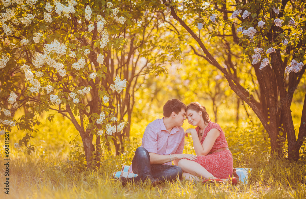 Portrait of young couple in flowering park Portrait of young couple in flowering park