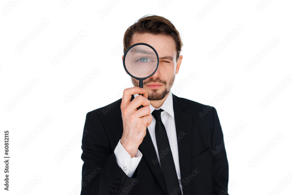 Businessman looking through a magnifying glass Businessman looking through a magnifying glass