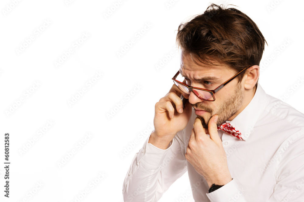 Nerdy businessman talking on a smartphone Nerdy businessman talking on a smartphone