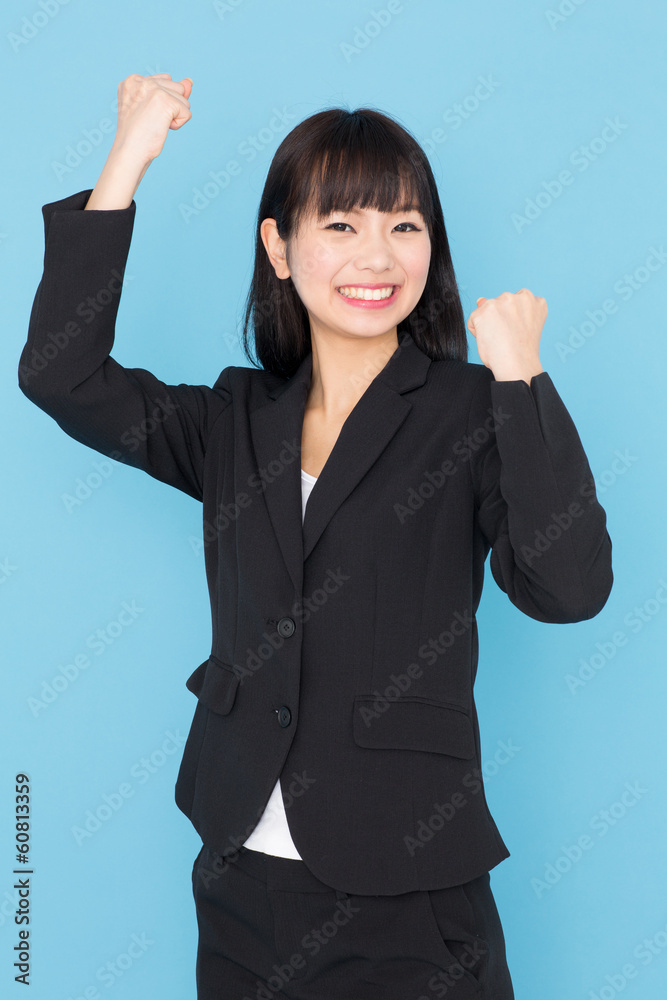 asian businesswoman cheering on blue background asian businesswoman cheering on blue background