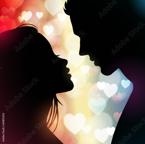 Couple silhouette with hearts in the background