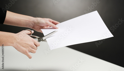 cutting paper with scissors