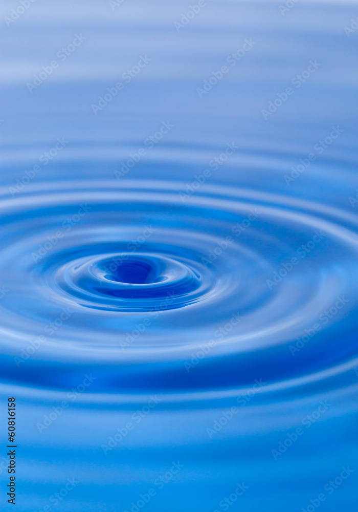 a drop of water falling into the water. macro a drop of water falling into the water. macro