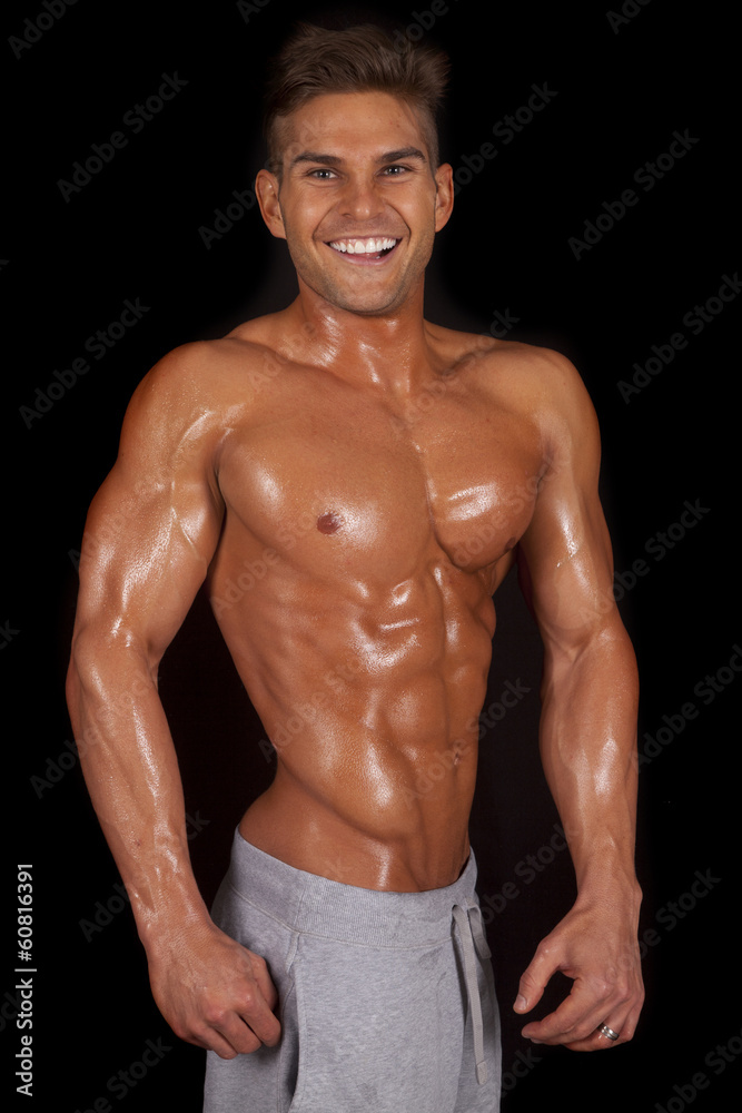Fototapeta premium man no shirt shiny showing muscles smiling