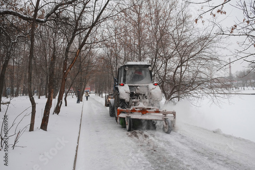 snow-removal tractor cleans alley in the park