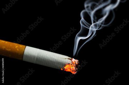 burning cigarette with smoke photo
