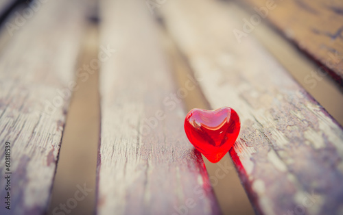 macro red heart on a vintage wooden chair