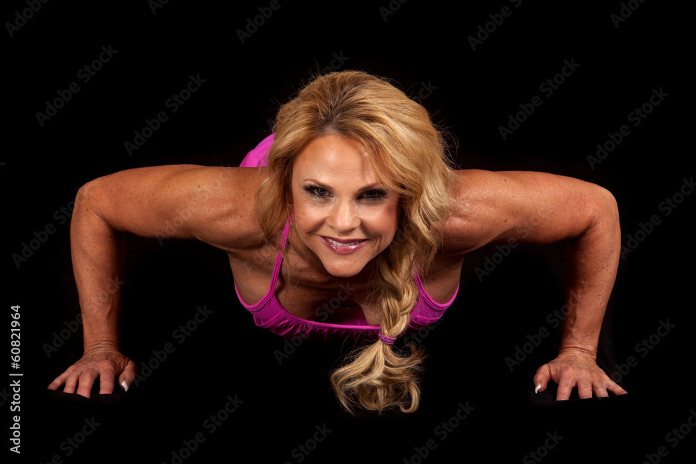 Woman pink on black pushup down looking smile Woman pink on black pushup down looking smile