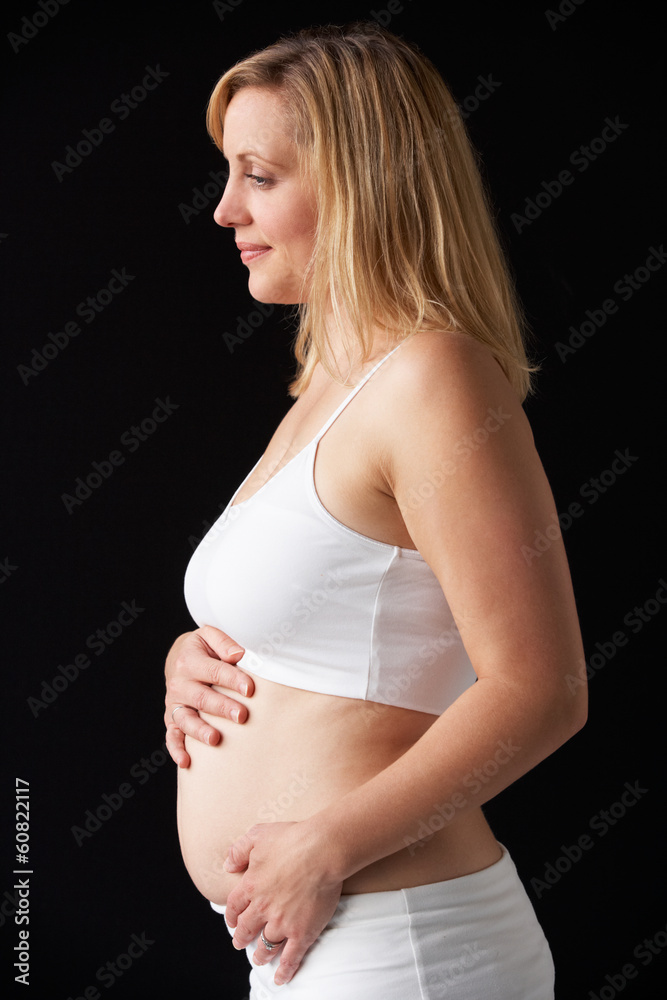 Portrait Of 4 months Pregnant Woman Wearing White On Black Backg Portrait Of 4 months Pregnant Woman Wearing White On Black Backg