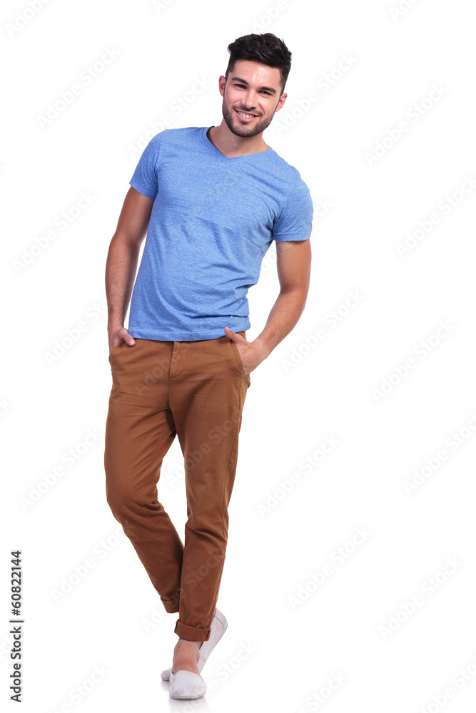 casual man standing with hands in pockets and smiles casual man standing with hands in pockets and smiles