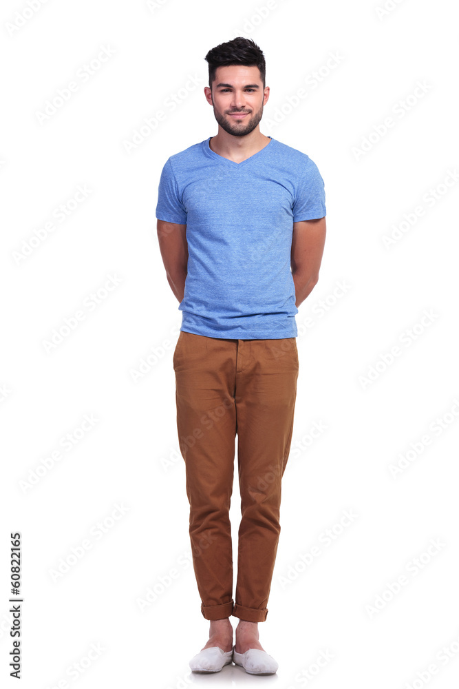 Fototapeta premium man standing straight with hands at his back