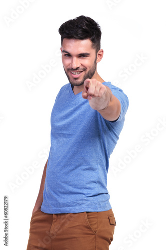 smiling casual man pointing his finger to the camera