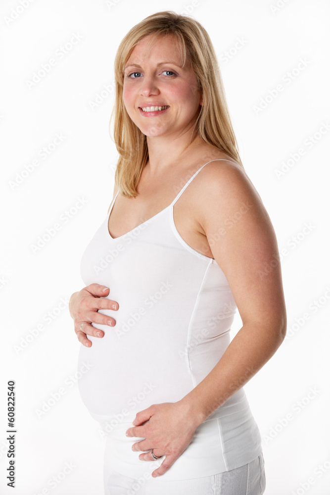 Studio Portrait Of 5 months Pregnant Woman Wearing White Studio Portrait Of 5 months Pregnant Woman Wearing White