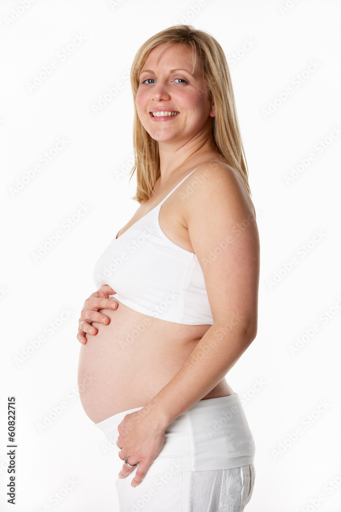 Studio Portrait Of 5 months Pregnant Woman Wearing White Studio Portrait Of 5 months Pregnant Woman Wearing White
