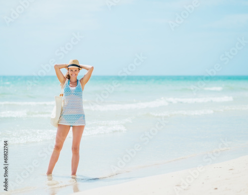 Wallpaper Mural Young woman standing on beach Torontodigital.ca