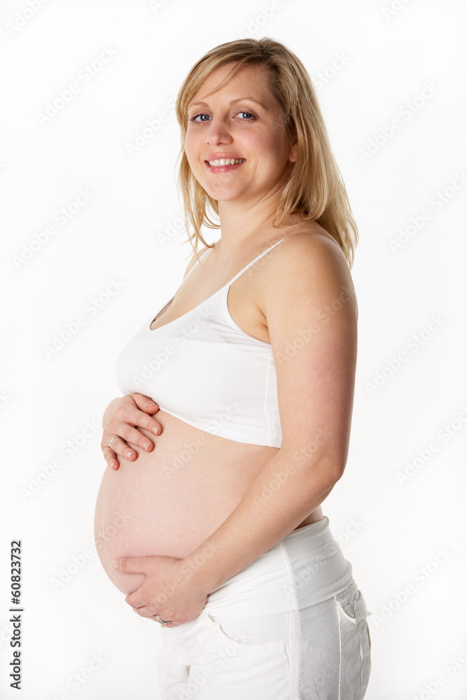 Studio Portrait Of 6 months Pregnant Woman Wearing White Studio Portrait Of 6 months Pregnant Woman Wearing White