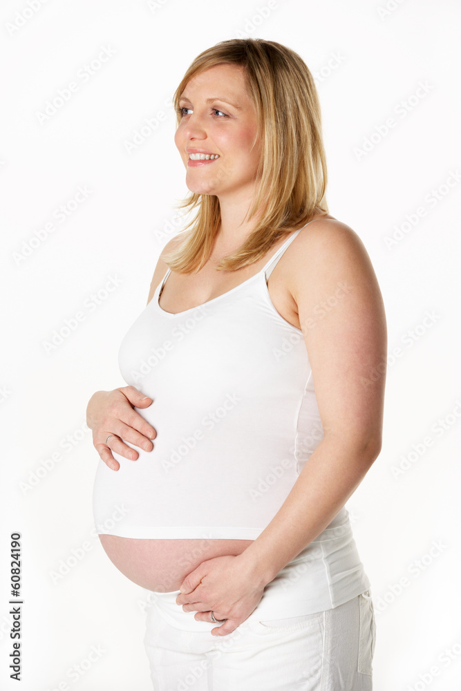 Studio Portrait Of 7 months Pregnant Woman Wearing White Studio Portrait Of 7 months Pregnant Woman Wearing White