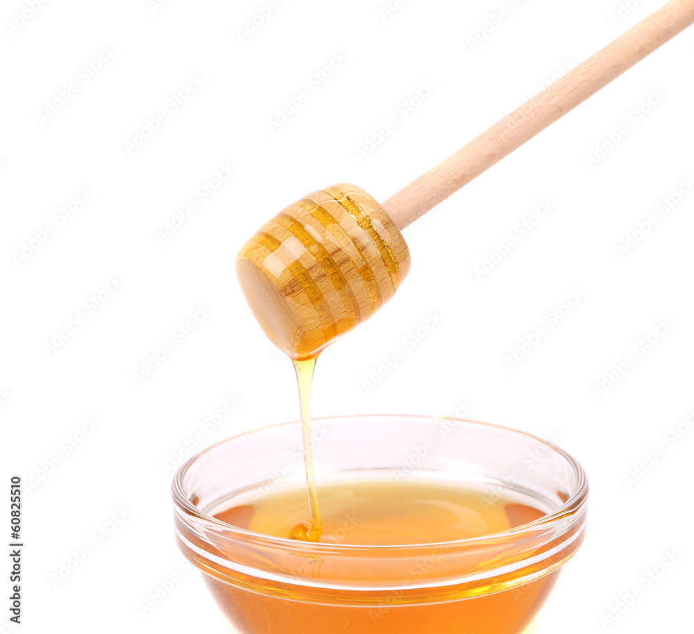 Bee honey with wooden dipper.