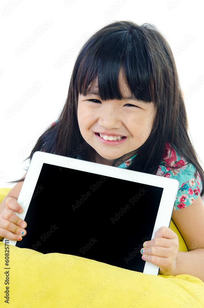 Little asian girl smiles with tablet computer