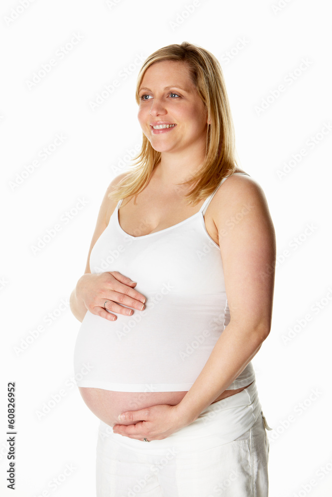 Studio Portrait Of 8 Months Pregnant Woman Wearing White Studio Portrait Of 8 Months Pregnant Woman Wearing White
