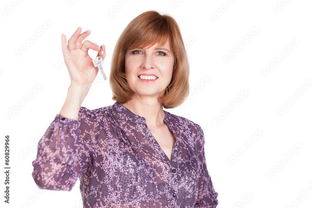 Pretty middle aged woman holding keys. Isolated on white Pretty middle aged woman holding keys. Isolated on white