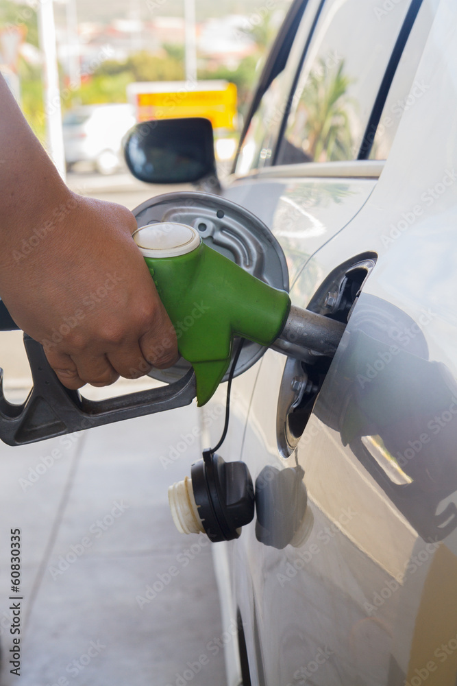 refilling car with fuel close up