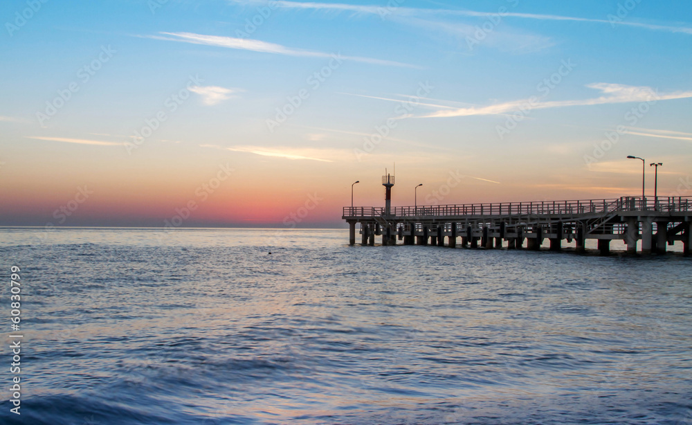 sea ​​and a pier at sunset
