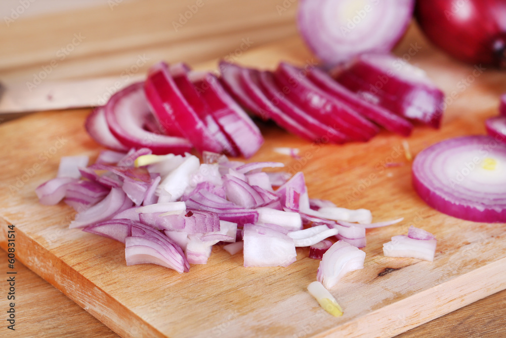 Cut onion on cutting board on wooden background