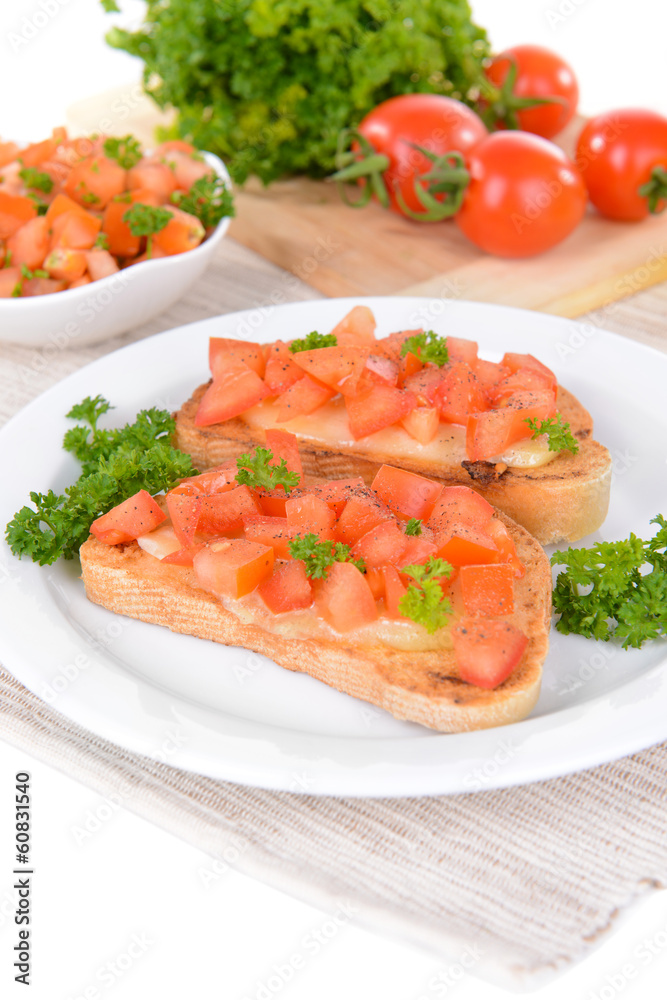 Delicious bruschetta with tomatoes on plate on table close-up