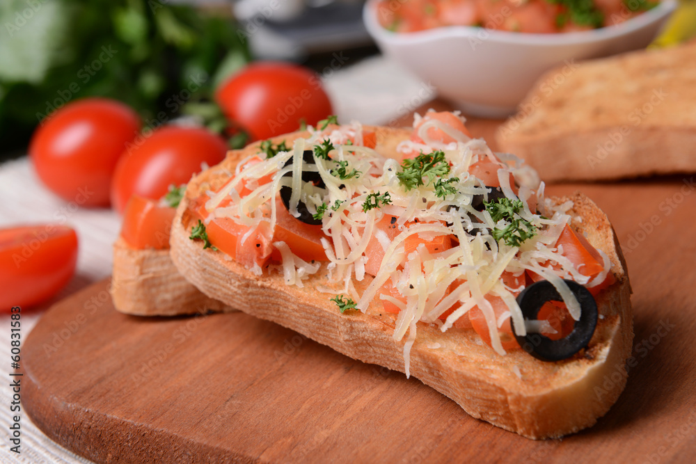 Delicious bruschetta with tomatoes on cutting board close-up Delicious bruschetta with tomatoes on cutting board close-up
