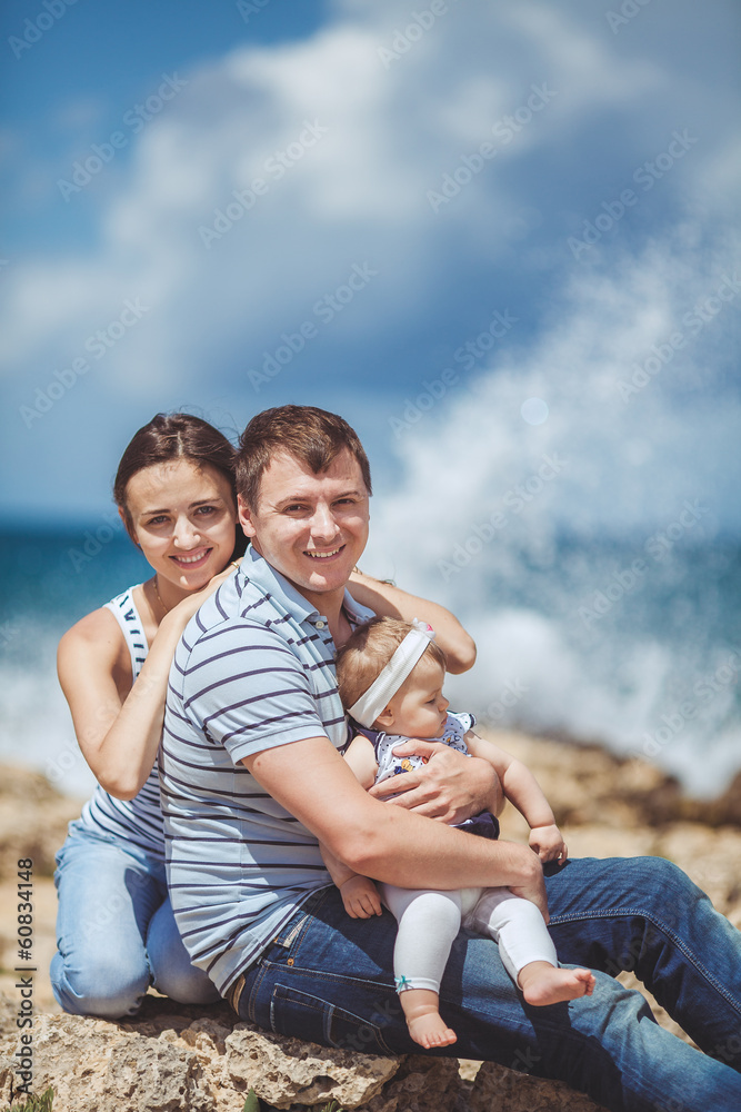 Portrait of a family of three having fun together on the ocean Portrait of a family of three having fun together on the ocean