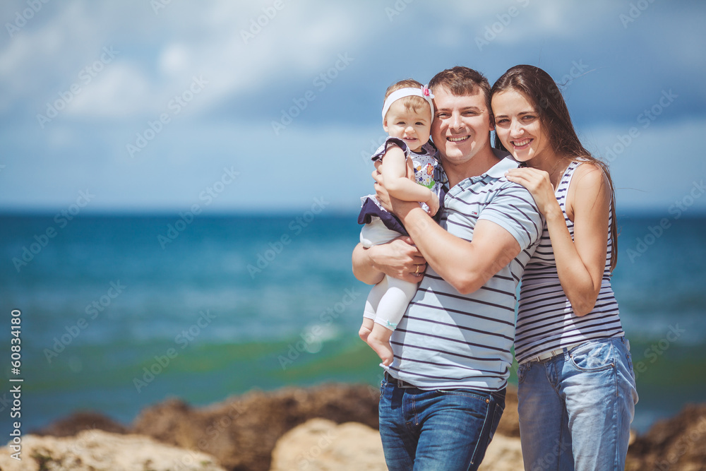 Portrait of a family of three having fun together on the ocean Portrait of a family of three having fun together on the ocean