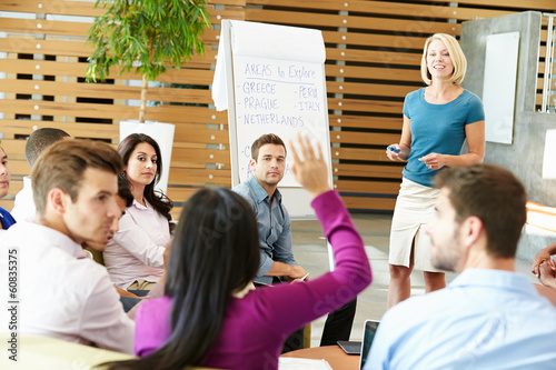 Businesswoman Making Presentation To Office Colleagues photo