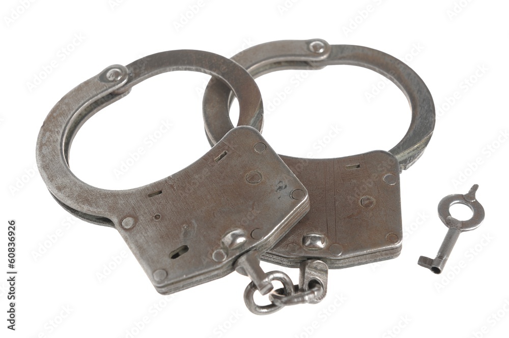 Obraz premium Handcuffs with a key on white
