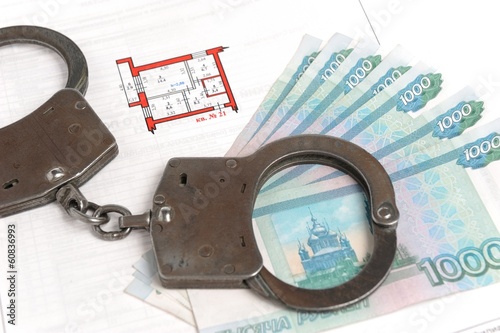 Obraz na plátně Handcuffs, money and technical passport with the plan of the apa
